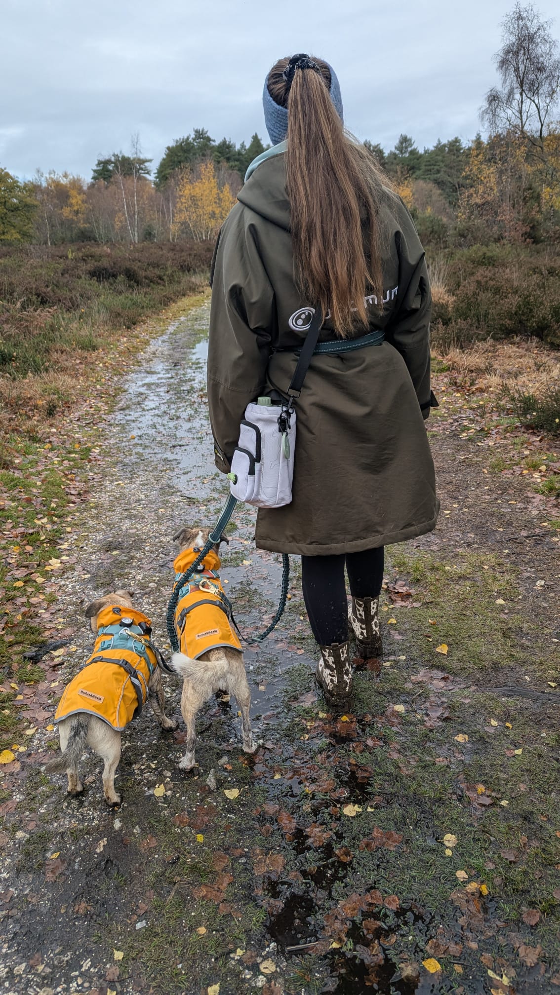 Dog owner walking with Contour Trail Bottle Bag and dog outdoors