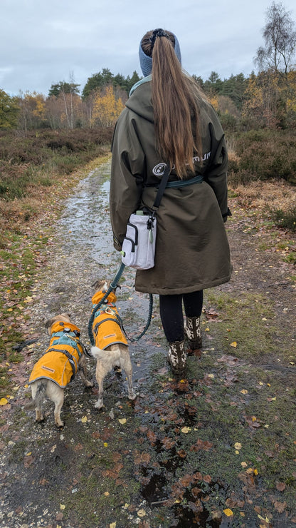 Dog owner walking with Contour Trail Bottle Bag and dog outdoors