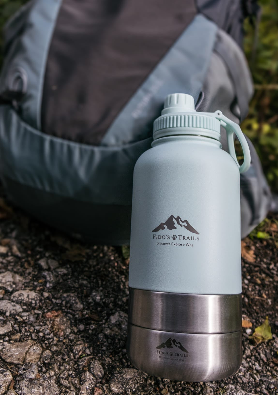Coastal Blue 3-in-1 dog water bottle placed on ground during outdoor walk