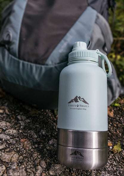 Coastal Blue 3-in-1 dog water bottle placed on ground during outdoor walk