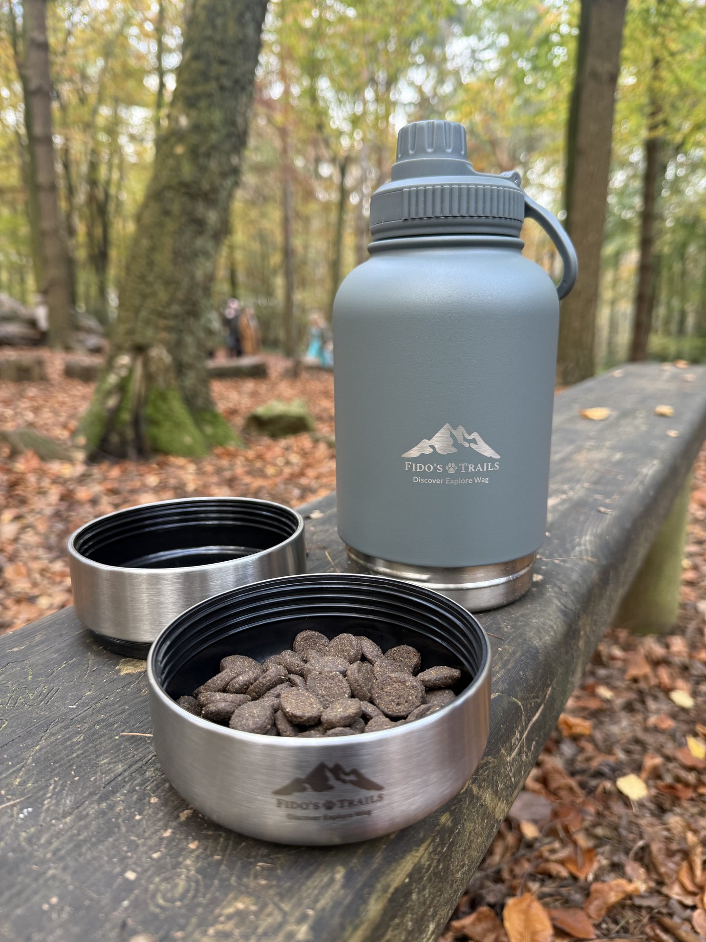 Mountain Grey 3-in-1 dog water bottle with detachable bowls placed outdoors