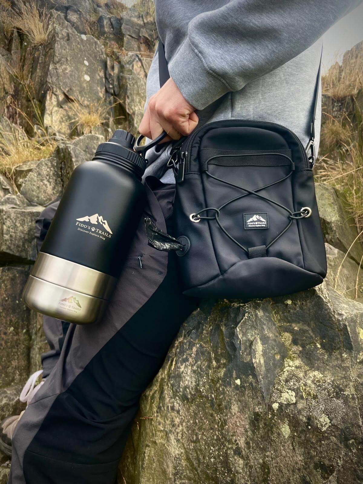 Dog owner wearing tactical dog walking bag outdoors on adventure